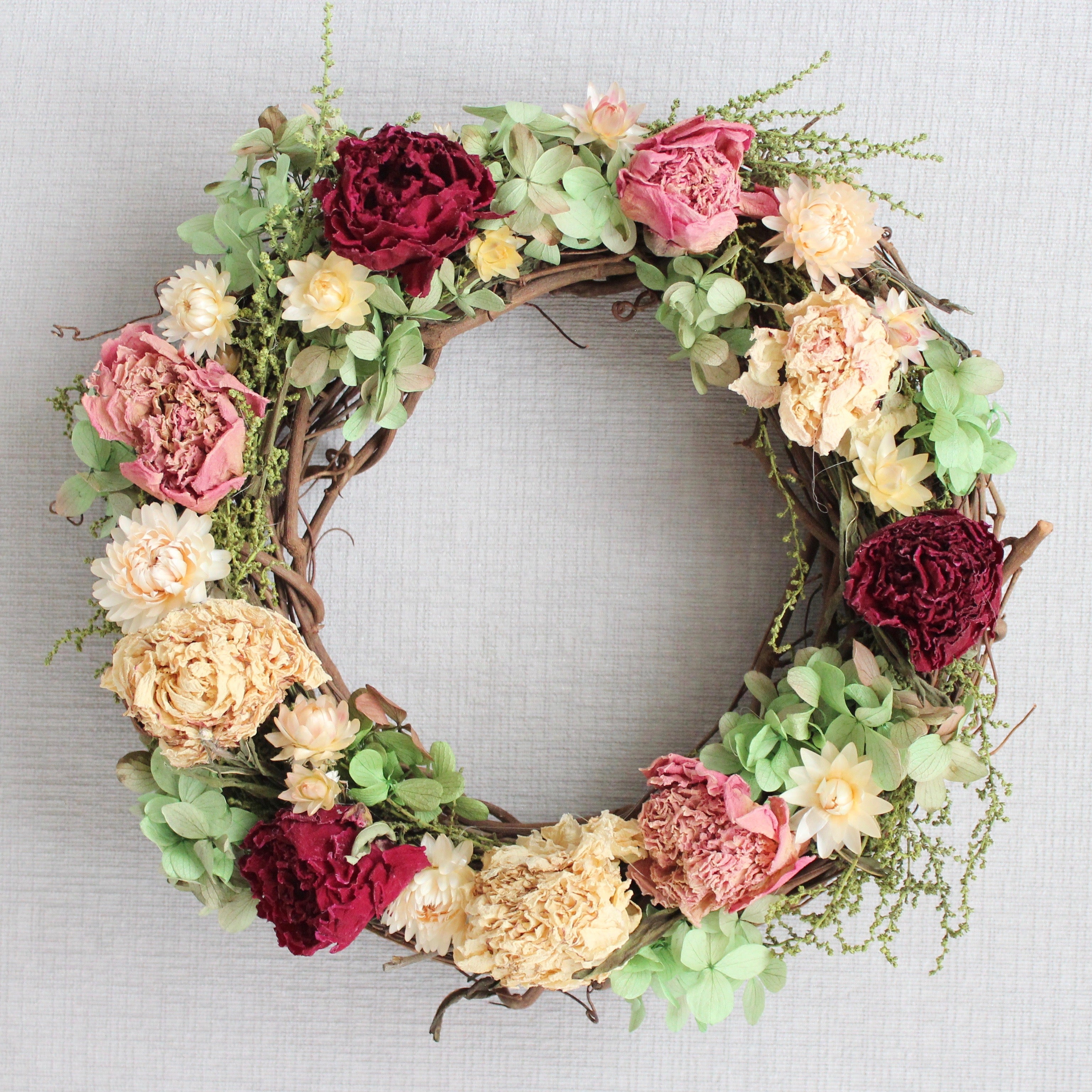 Dried Flower Wreath on a Grapevine base with Peonies, Hydrangea, Strawflowers, and Stoebe