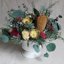 Load image into Gallery viewer, Dried Arrangement in White Urn featuring Caspia, Banksia, Protea Compacta, Cockscomb, Greek Oregano, Plumosus Fern, Eucalyptus, and Peony
